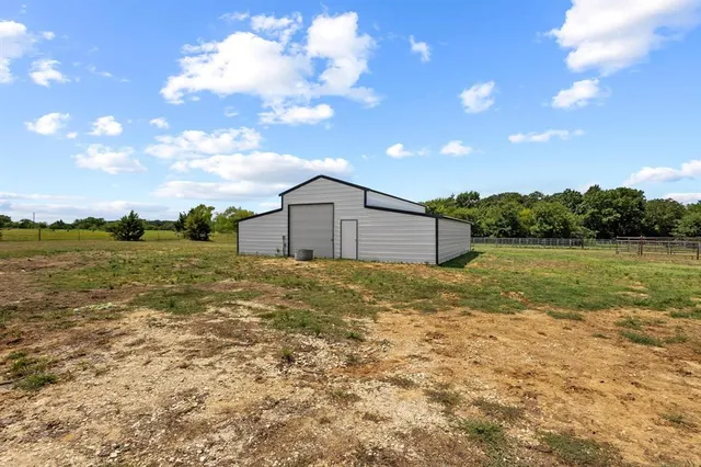 a backyard of a house with lots of green space and lake view