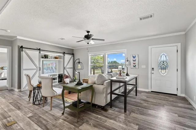 a living room with furniture and wooden floor