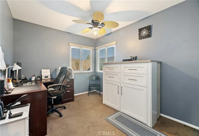 a view of workspace with wooden floor and ceiling fan