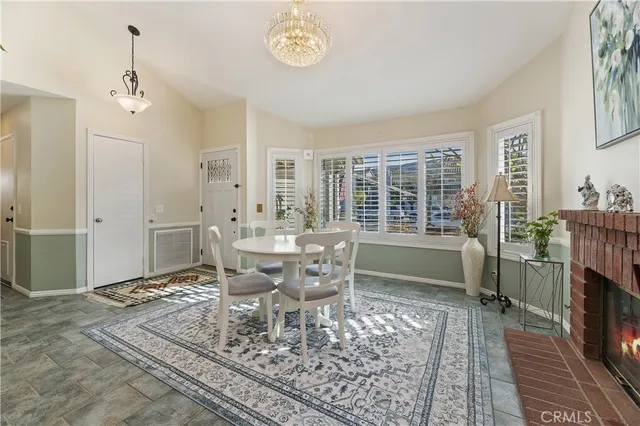 a dining room with furniture a rug and a chandelier