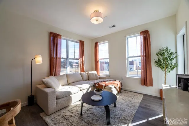a view of a a dining room with furniture window and wooden floor