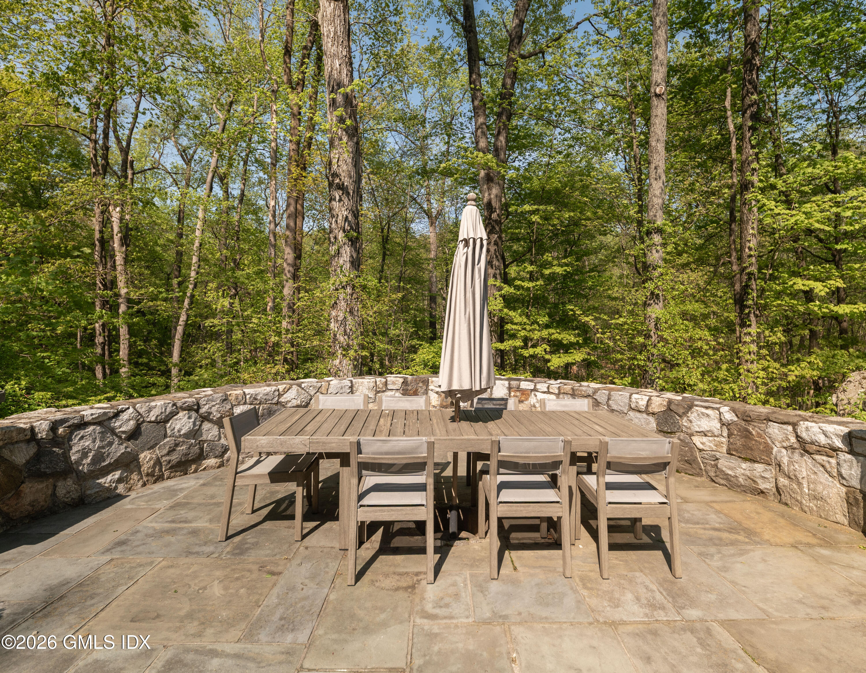 386 Taconic Road Greenwich, CT 06831 - Photo 19 of 22 a view of a patio with table and chairs and couches