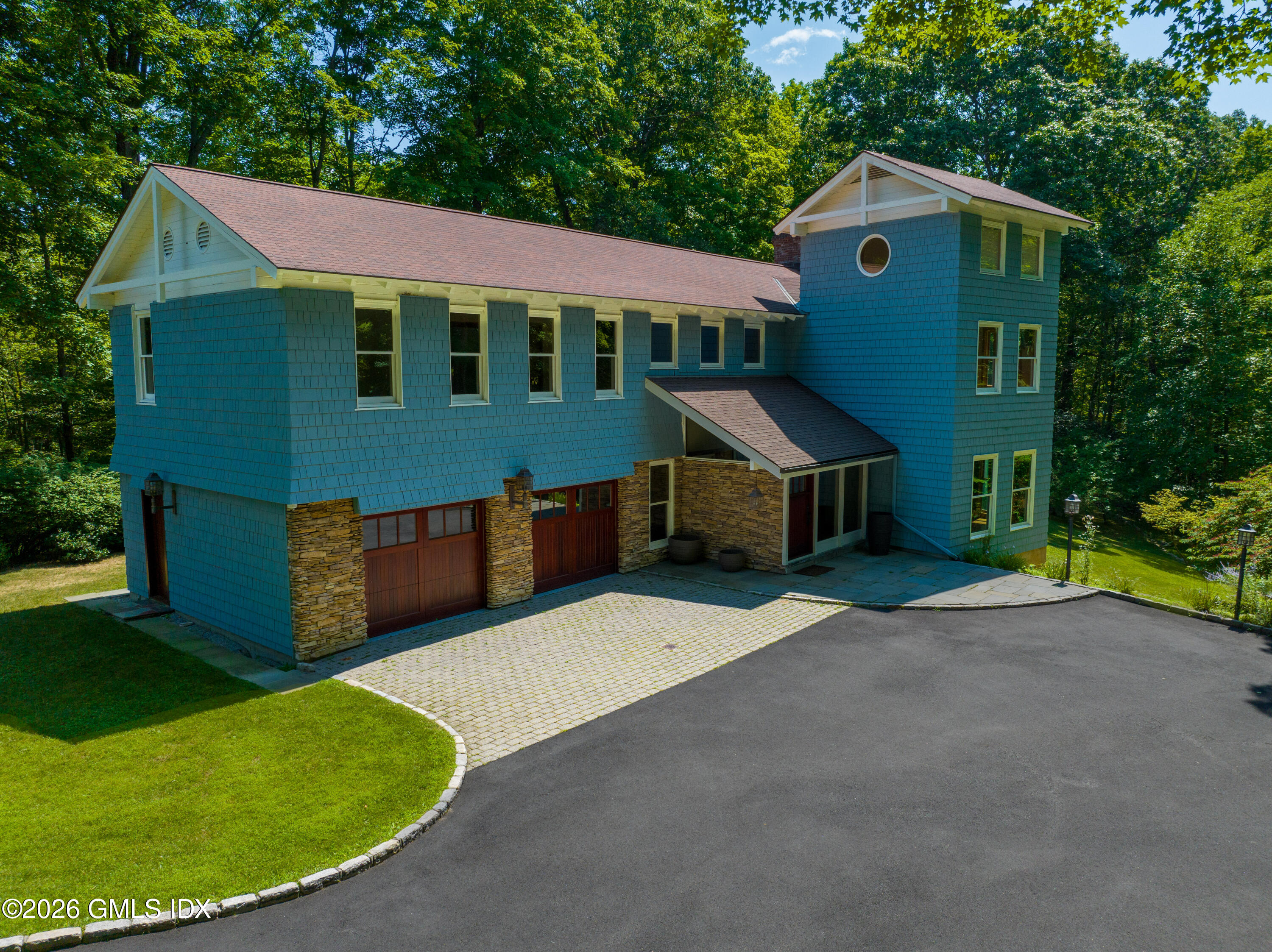 386 Taconic Road Greenwich, CT 06831 - Photo 2 of 22 a front view of a house with a yard and garage