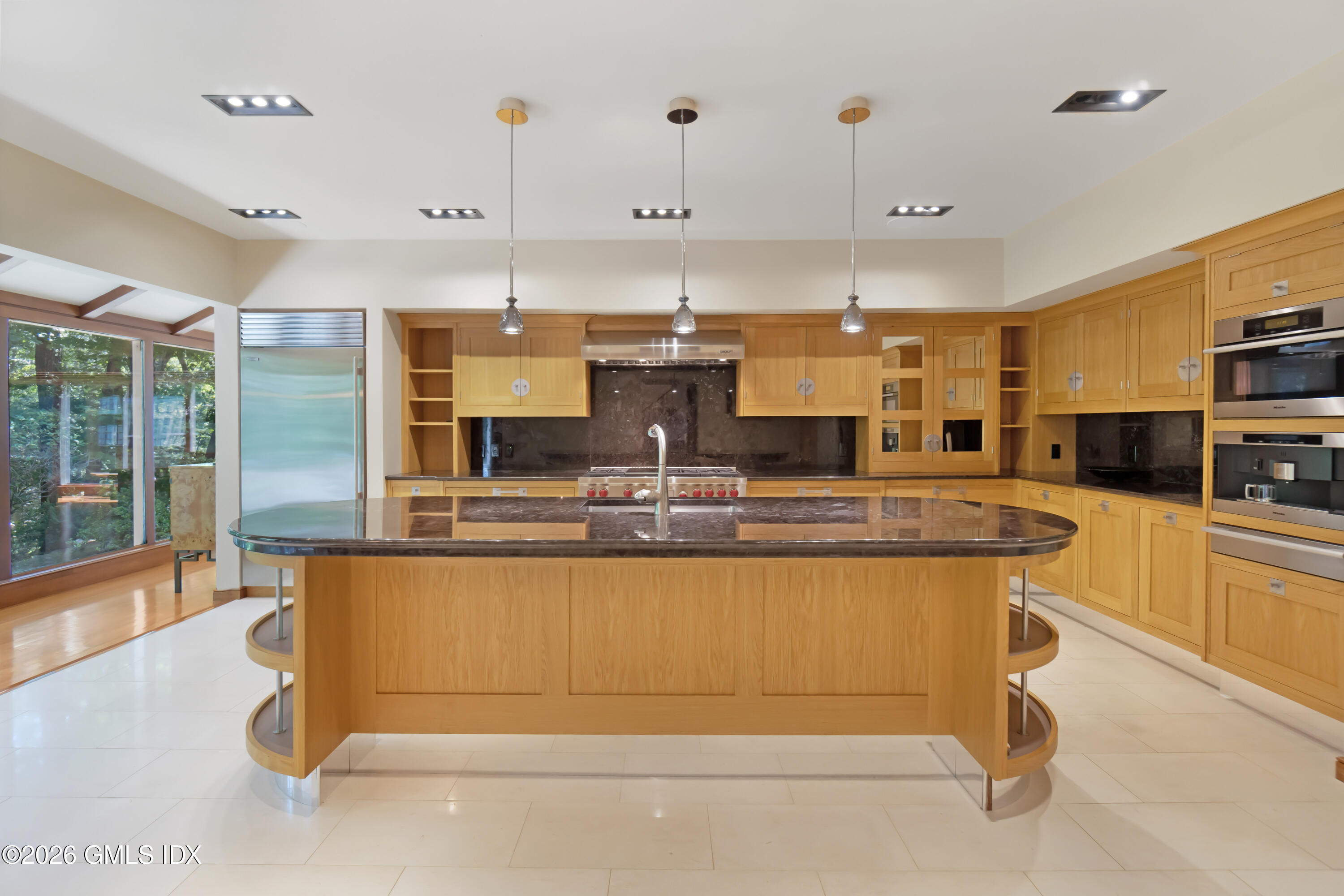 386 Taconic Road Greenwich, CT 06831 - Photo 5 of 22 a kitchen with kitchen island a counter top space a sink stainless steel appliances and cabinets