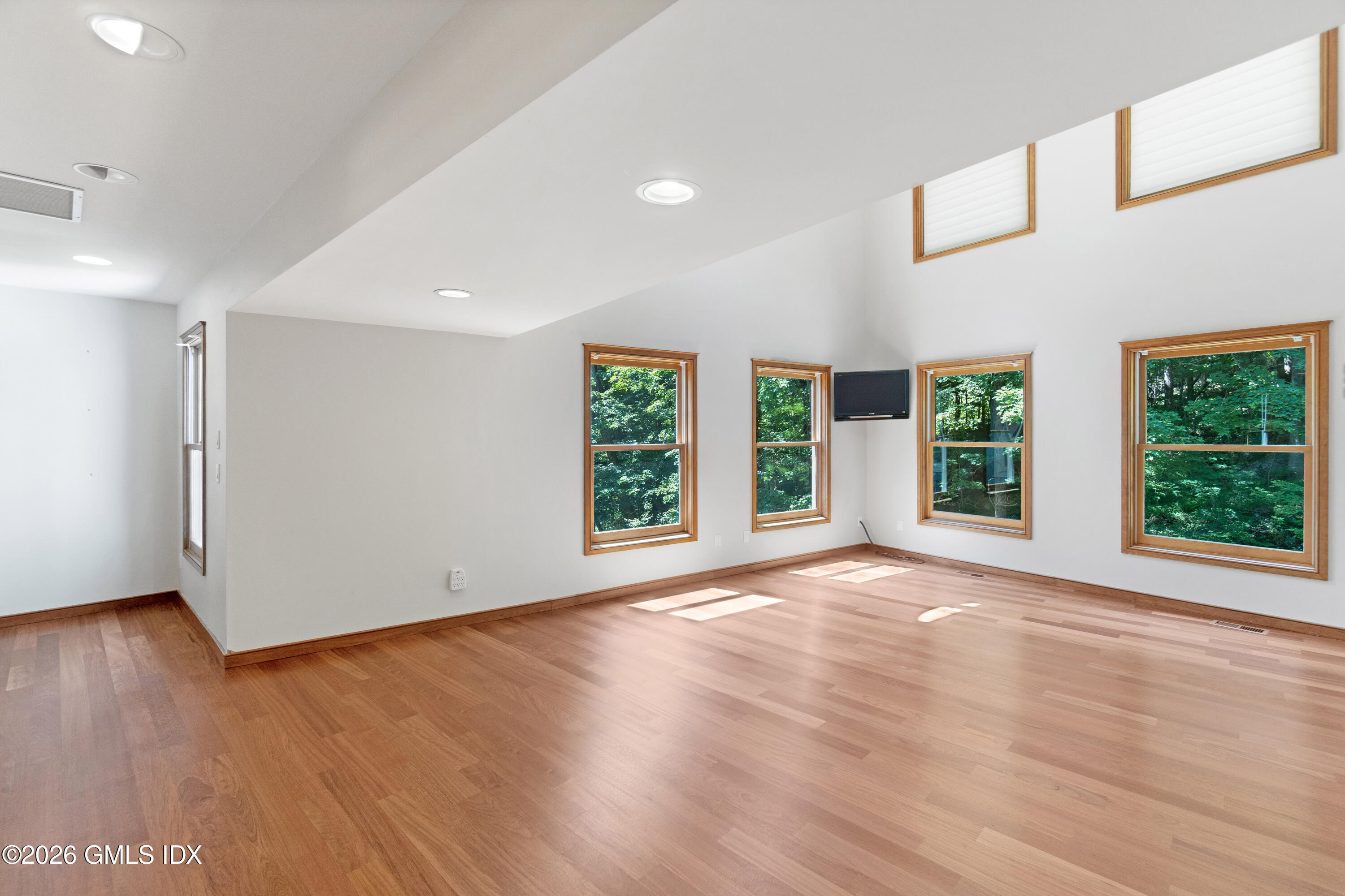 386 Taconic Road Greenwich, CT 06831 - Photo 10 of 22 a view of an empty room with wooden floor and a window