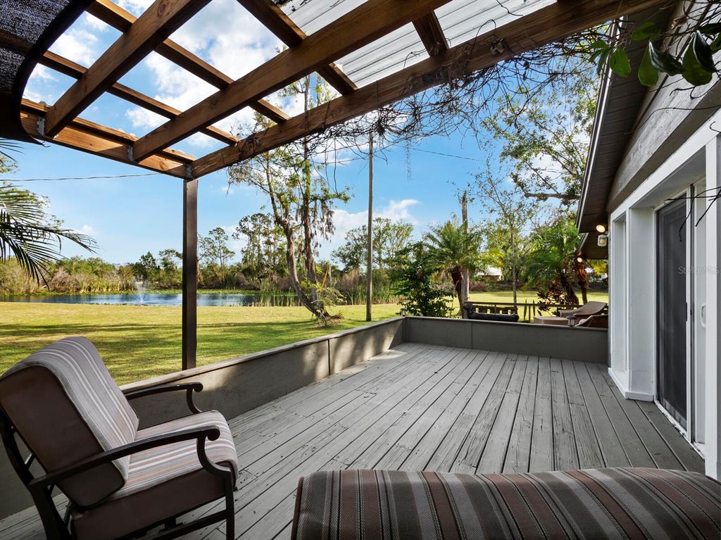 5645 Churchill Downs Road Sarasota, FL 34241 - Photo 14 of 41 a view of a balcony with lake view and a couches