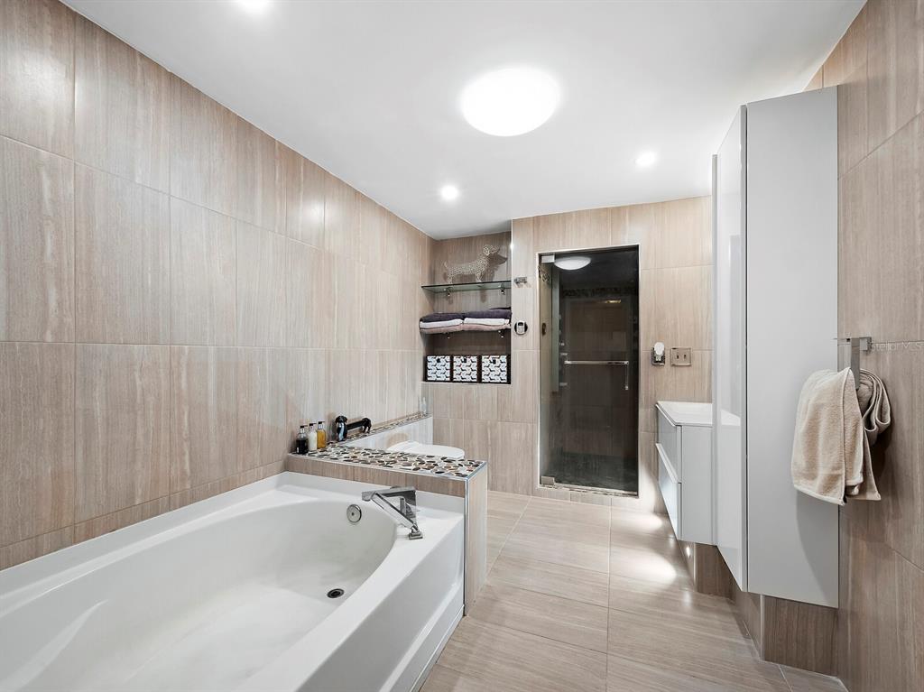 5645 Churchill Downs Road Sarasota, FL 34241 - Photo 20 of 41 a bathroom with a bathtub and a shower