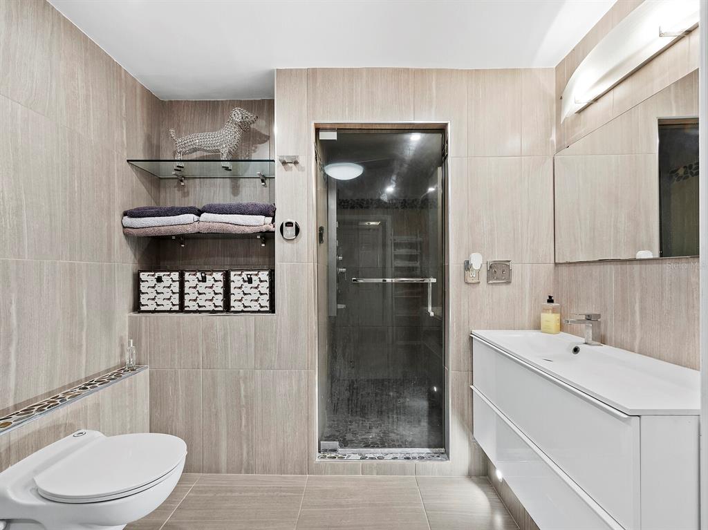 5645 Churchill Downs Road Sarasota, FL 34241 - Photo 21 of 41 a bathroom with a sink a toilet and shower