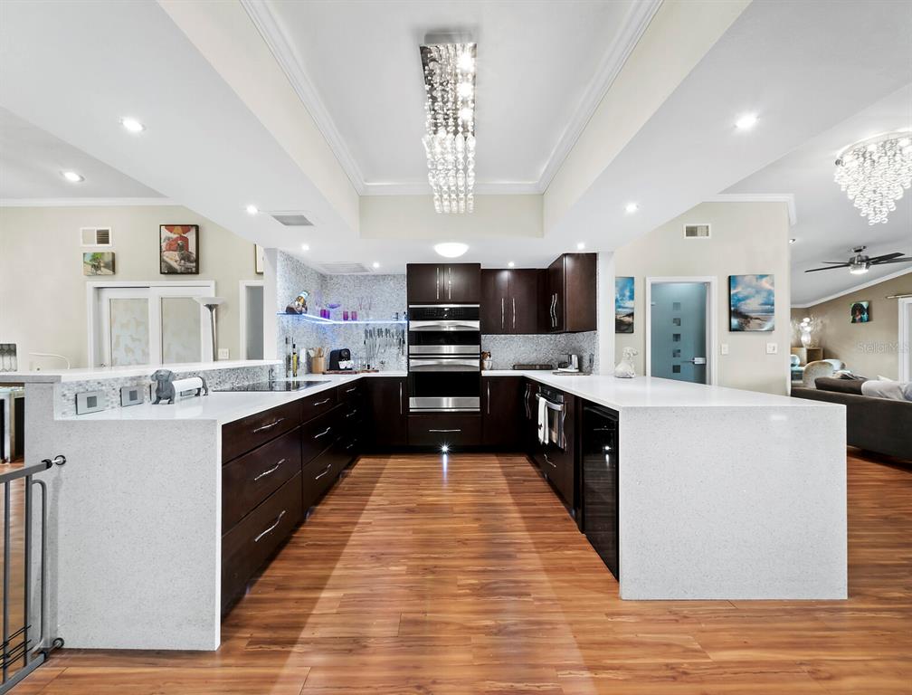 5645 Churchill Downs Road Sarasota, FL 34241 - Photo 7 of 41 a large kitchen with stainless steel appliances and a view of living room