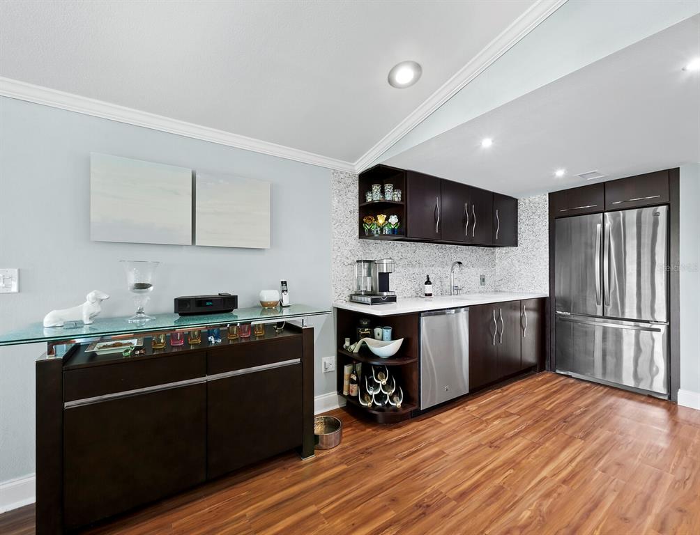 5645 Churchill Downs Road Sarasota, FL 34241 - Photo 9 of 41 a kitchen with stainless steel appliances a stove sink and refrigerator