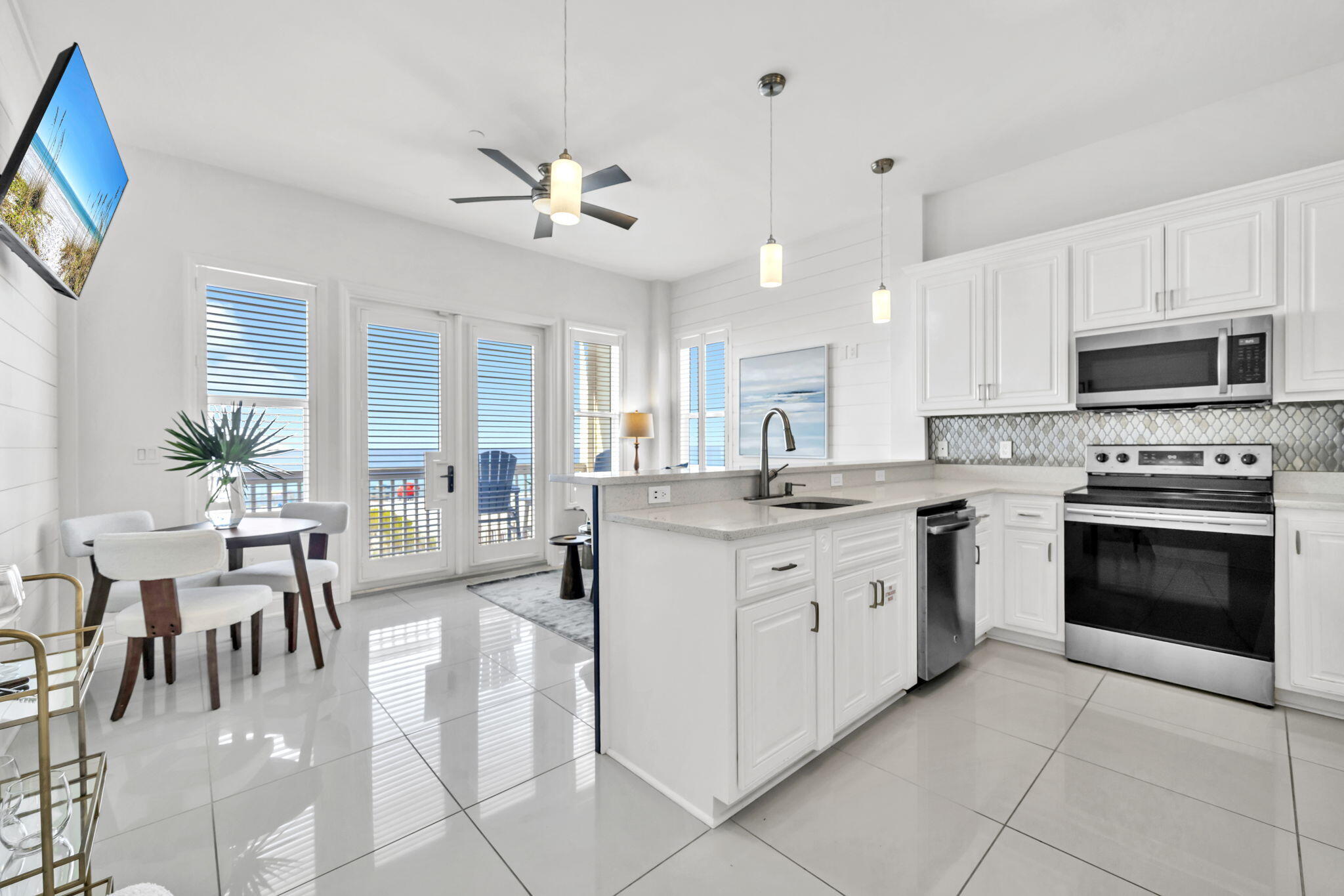 613 Eastern Lake Road, Unit 3 Santa Rosa Beach, FL 32459 - Photo 13 of 38 a kitchen with granite countertop a stove a sink and a refrigerator