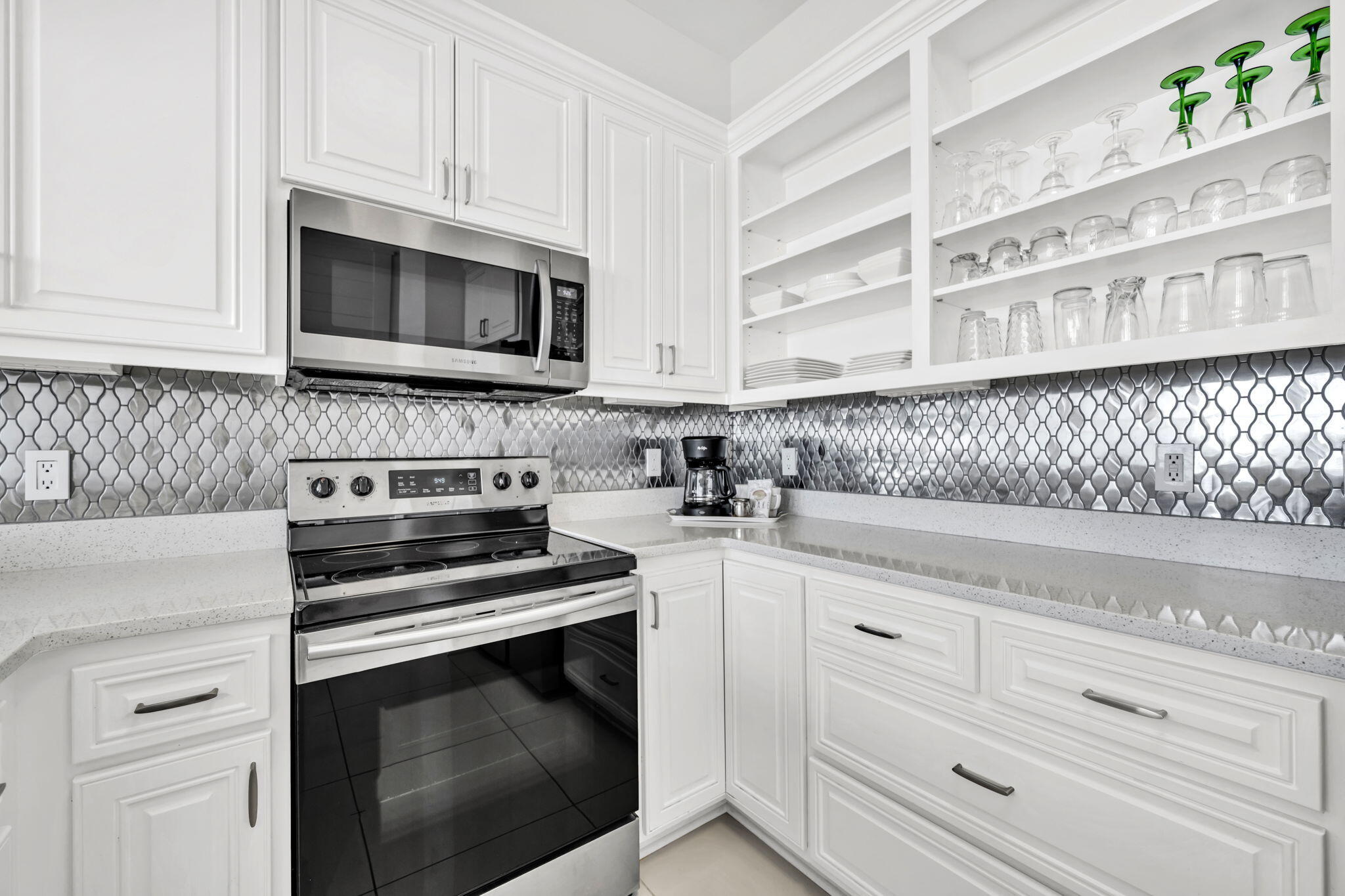 613 Eastern Lake Road, Unit 3 Santa Rosa Beach, FL 32459 - Photo 16 of 38 a kitchen with white cabinets and appliances