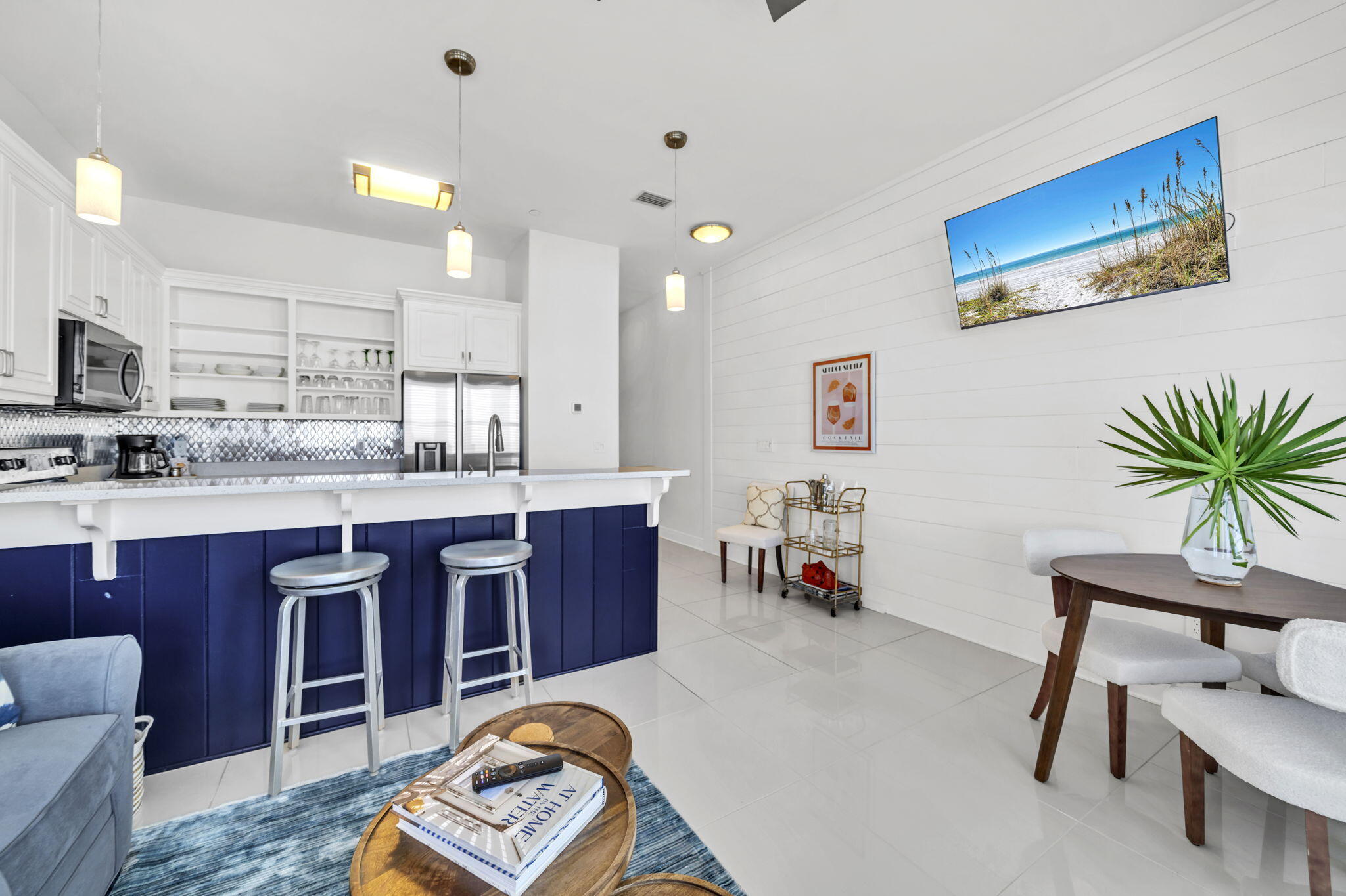 613 Eastern Lake Road, Unit 3 Santa Rosa Beach, FL 32459 - Photo 9 of 38 a large kitchen with stainless steel appliances granite countertop a stove a sink dishwasher and a dining table with the kitchen view