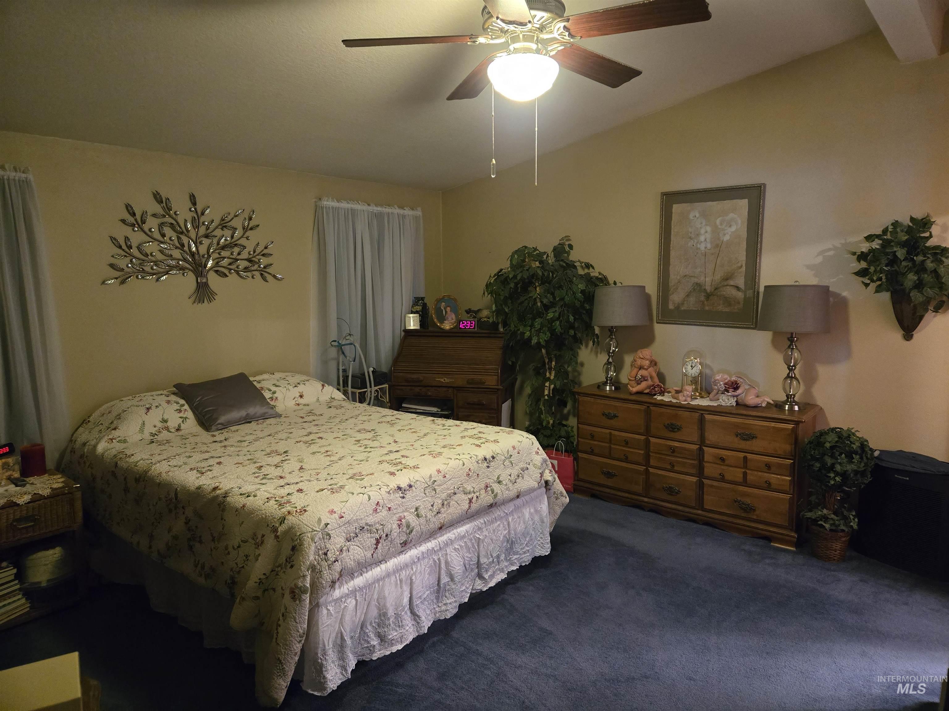254 Lackey Road Weippe, ID 83553 - Photo 11 of 38 Carpeted bedroom with vaulted ceiling and ceiling fan