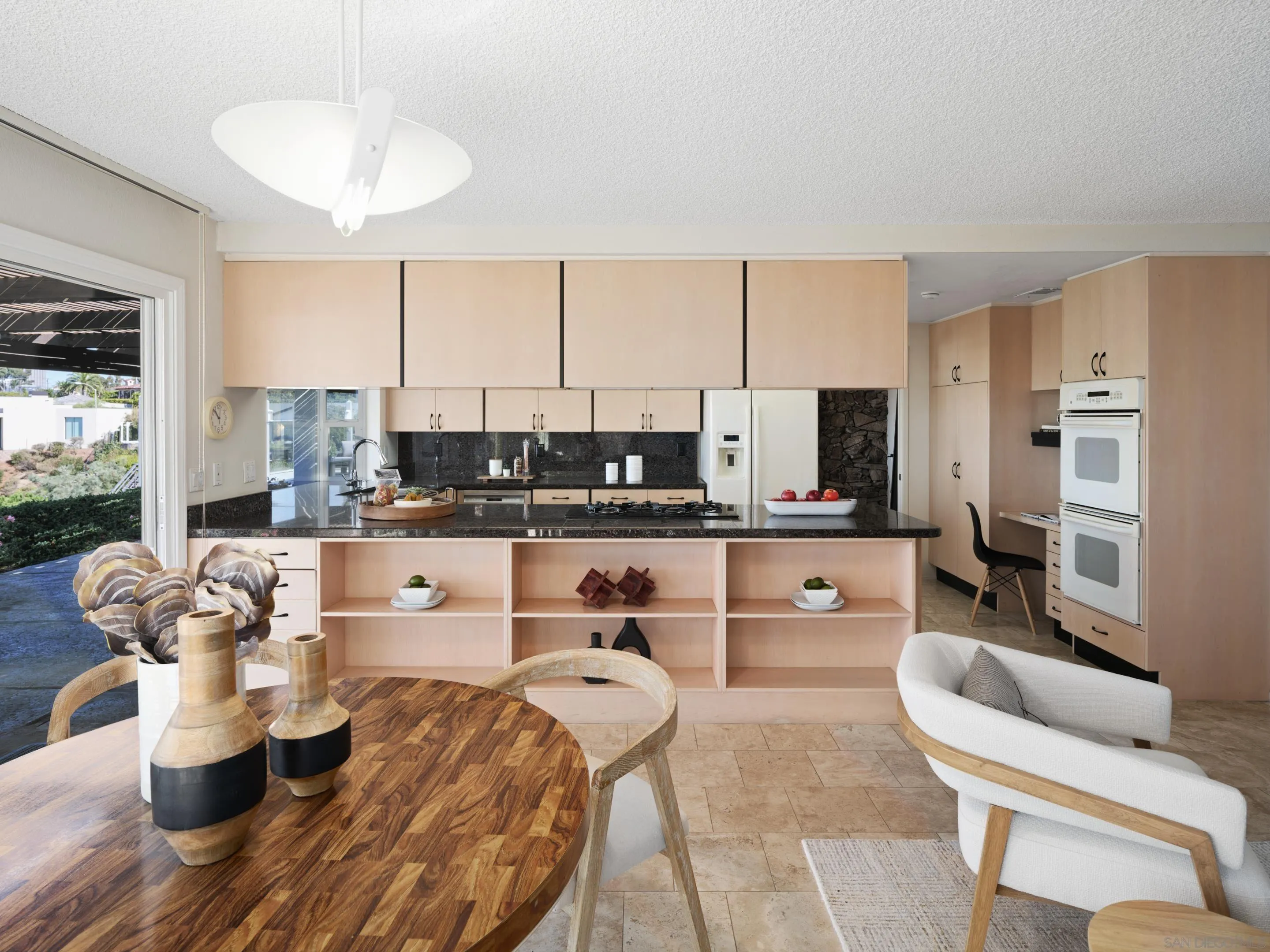 8568 Prestwick Drive La Jolla, CA 92037 - Photo 17 of 39 a living room with furniture kitchen view and large windows