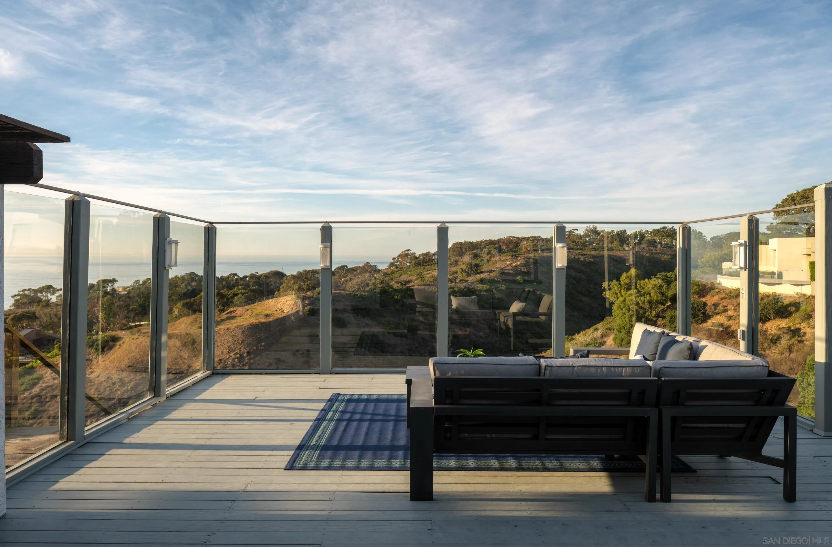 8568 Prestwick Drive La Jolla, CA 92037 - Photo 24 of 39 a view of a patio with lawn chairs and wooden floor