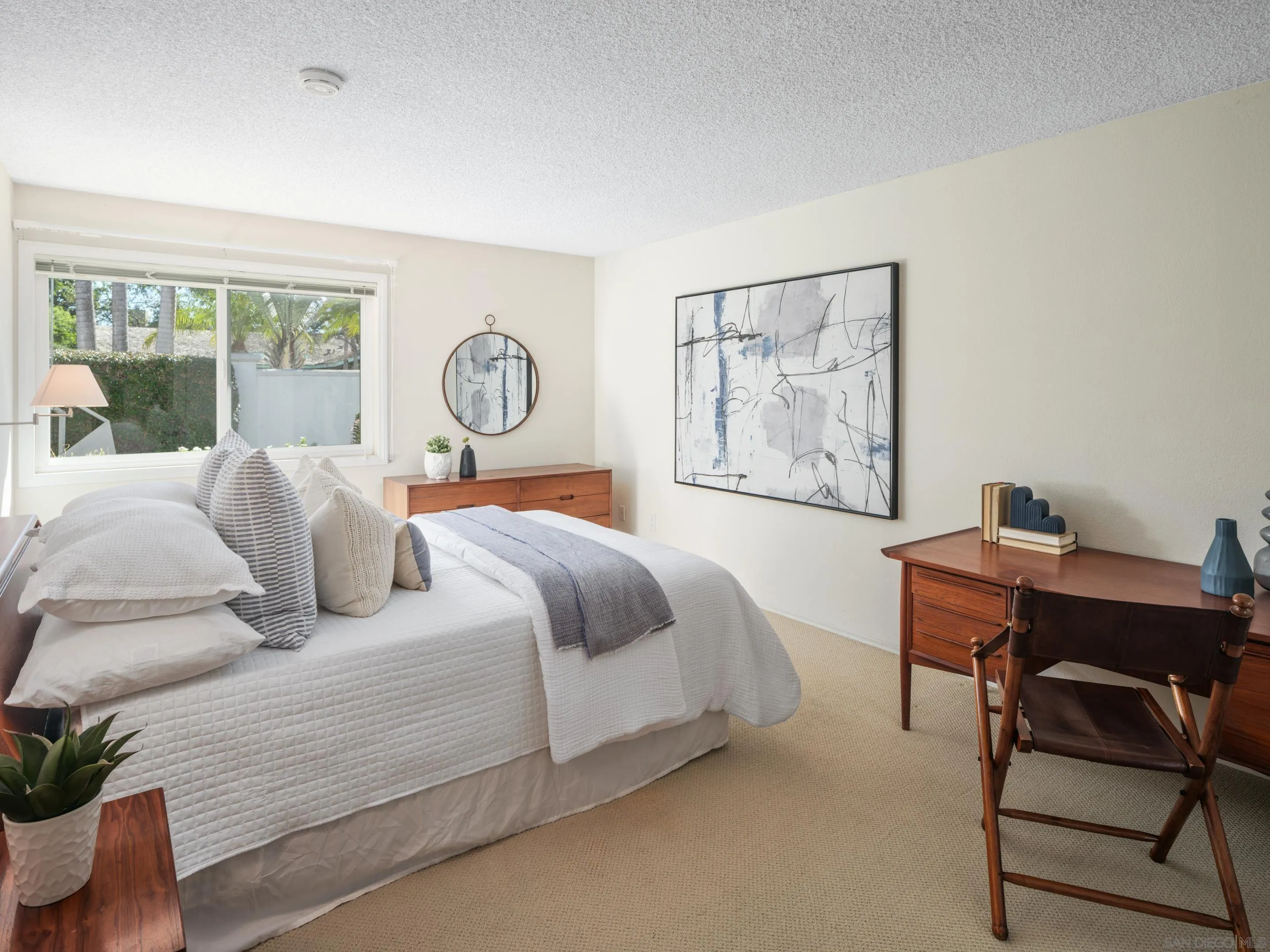 8568 Prestwick Drive La Jolla, CA 92037 - Photo 34 of 39 a bedroom with a large bed and a desk