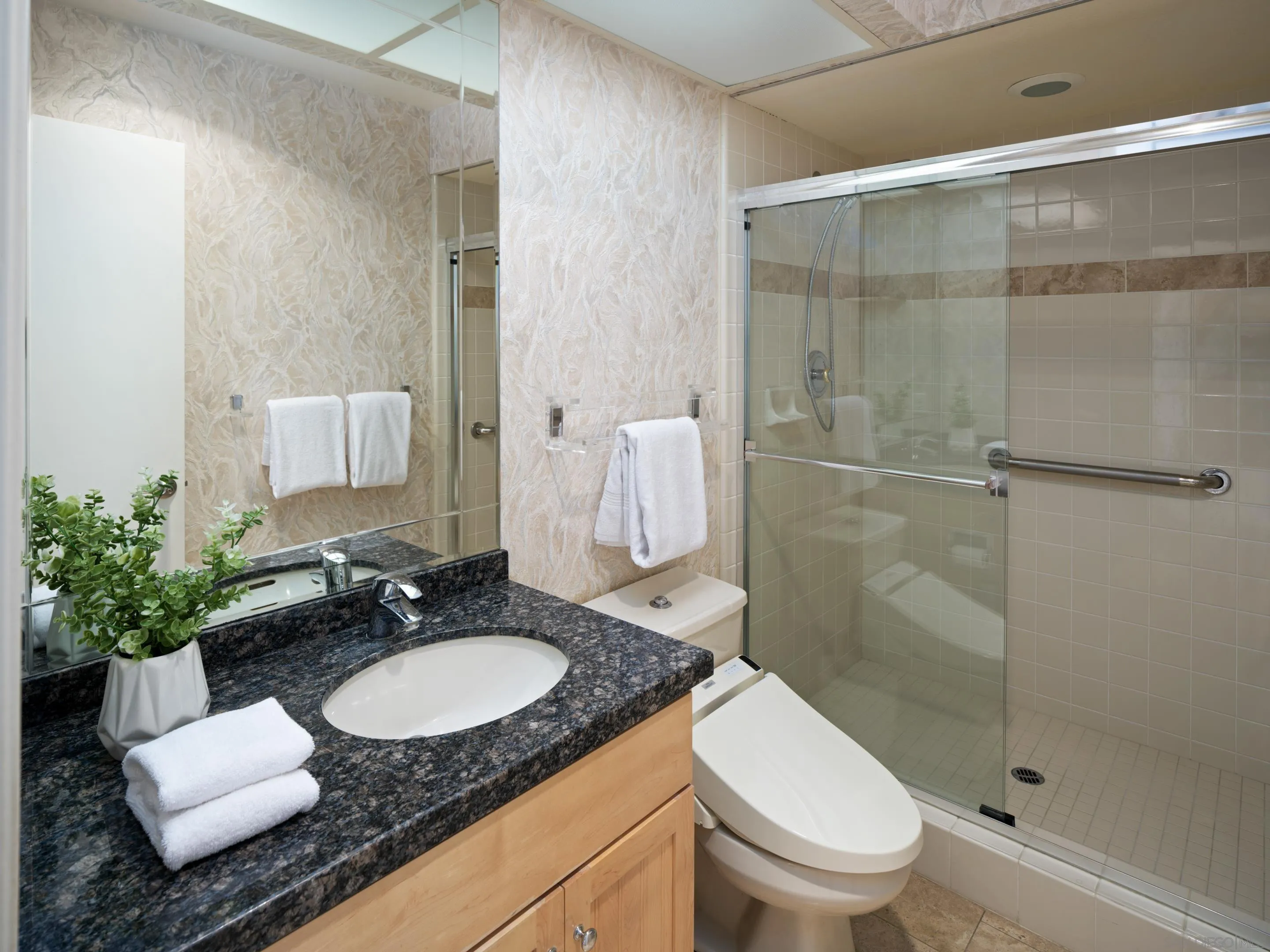 8568 Prestwick Drive La Jolla, CA 92037 - Photo 35 of 39 a bathroom with a granite countertop sink toilet a mirror and shower