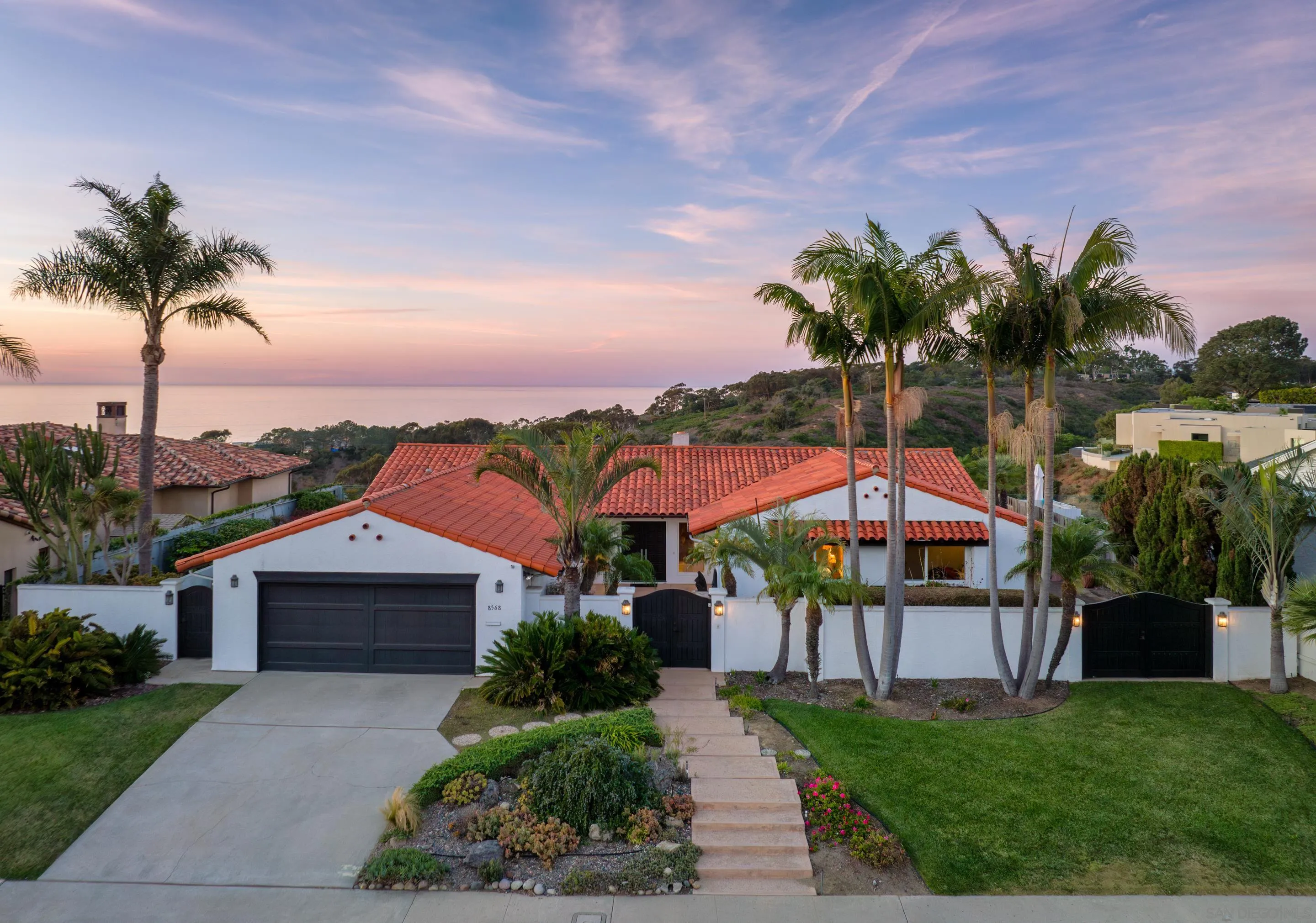 8568 Prestwick Drive La Jolla, CA 92037 - Photo 5 of 39 a view of a house with a yard and potted plants