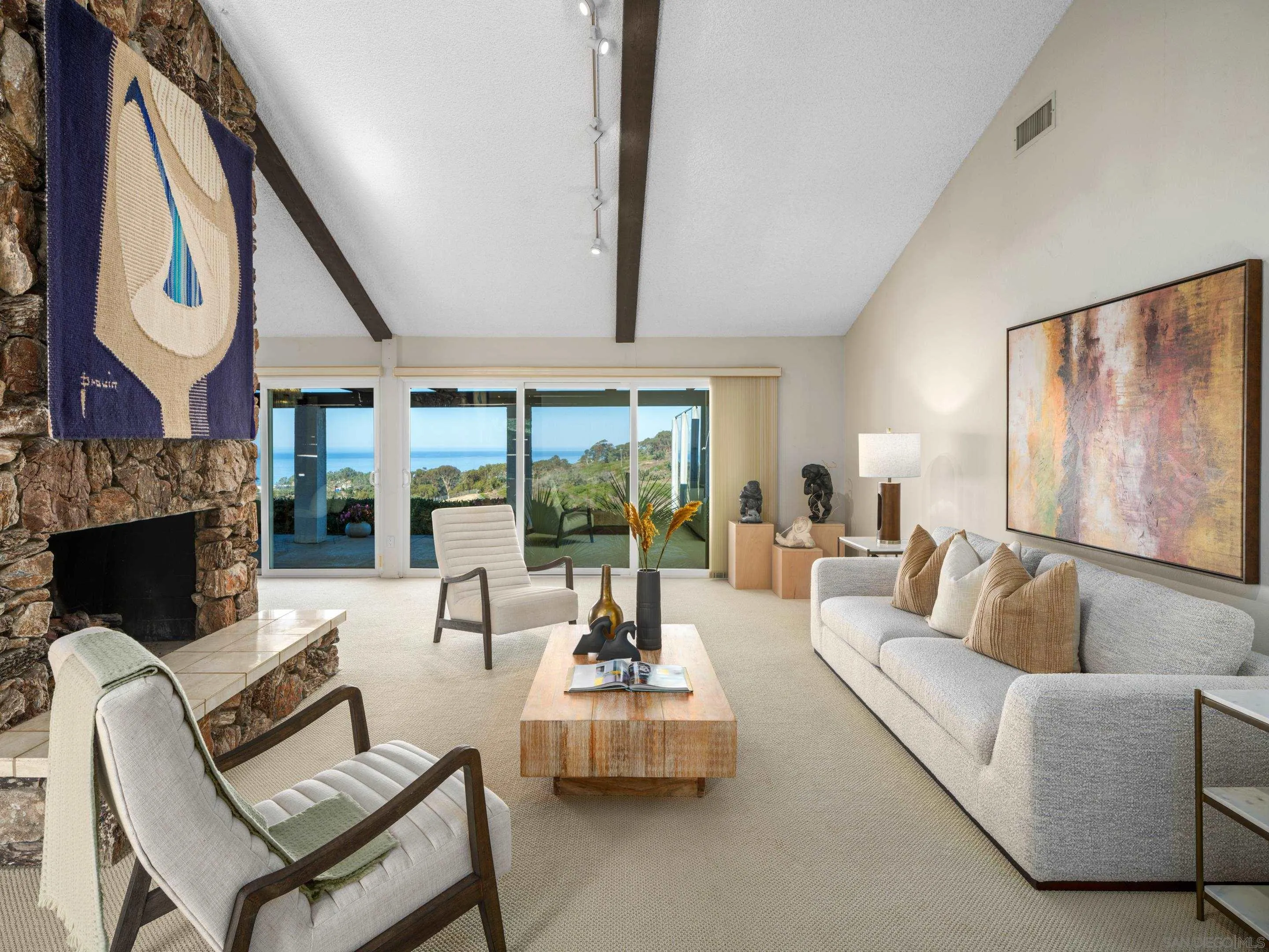 8568 Prestwick Drive La Jolla, CA 92037 - Photo 10 of 39 a living room with furniture fireplace and large windows