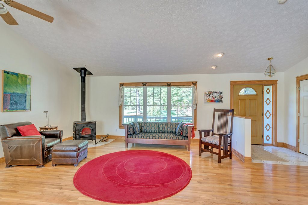 1452 Courthouse Road Palmyra, VA 22963 - Photo 16 of 44 a living room with furniture a rug and a floor to ceiling window