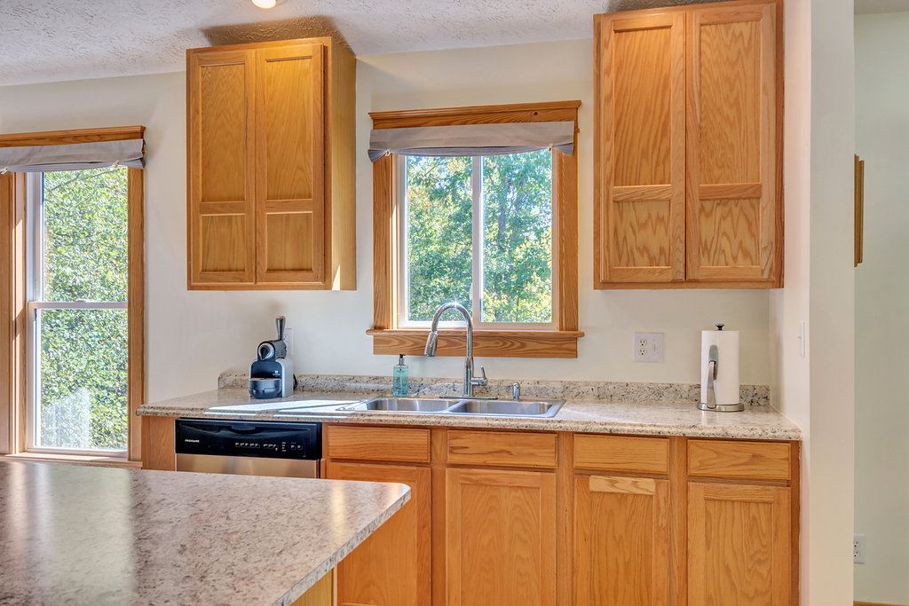 1452 Courthouse Road Palmyra, VA 22963 - Photo 21 of 44 a kitchen with stainless steel appliances granite countertop wooden cabinets a sink and a window