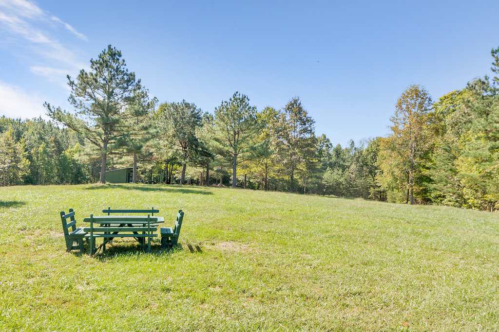 1452 Courthouse Road Palmyra, VA 22963 - Photo 36 of 44 a view of a lake with lawn chairs and wooden fence