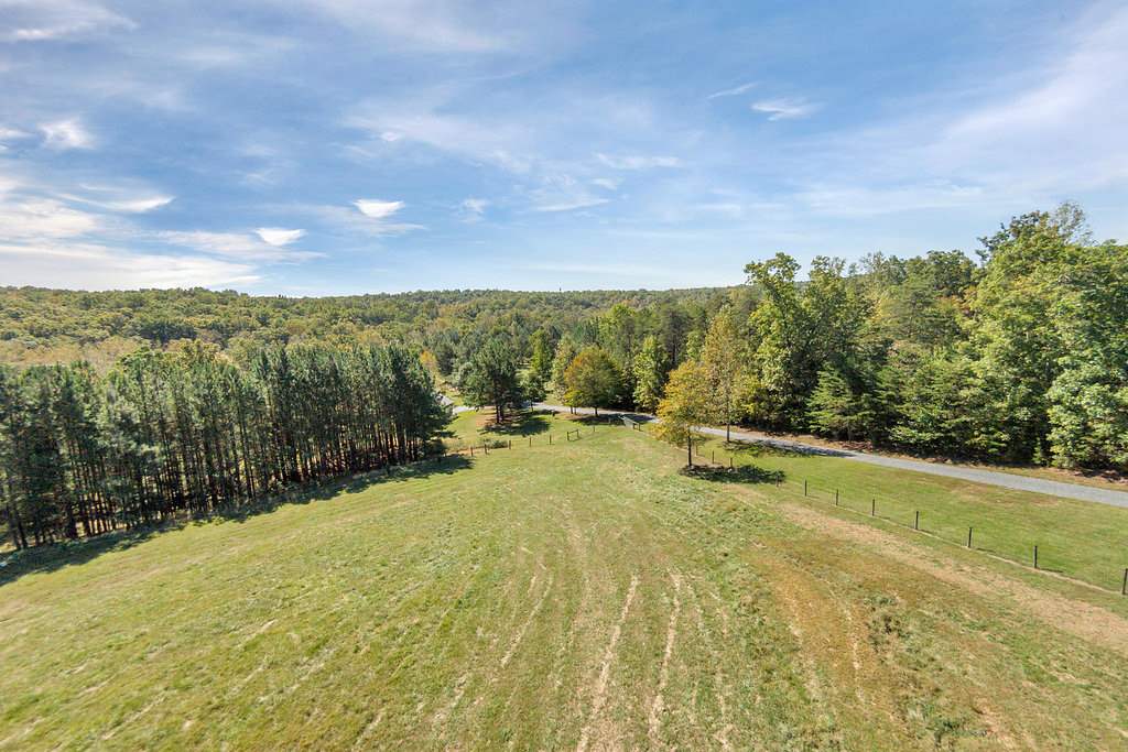 1452 Courthouse Road Palmyra, VA 22963 - Photo 6 of 44 a view of a yard with swimming pool and trees in the background