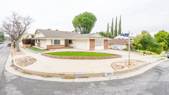 a view of a house with a small yard and plants