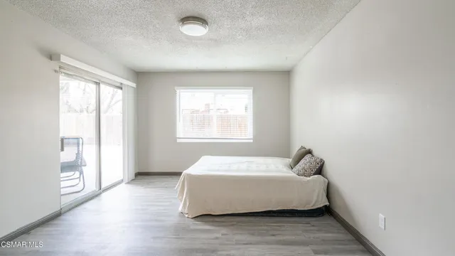 a bedroom with a bed and window