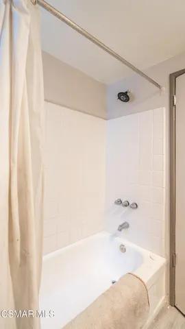 a bathroom with a bathtub and shower