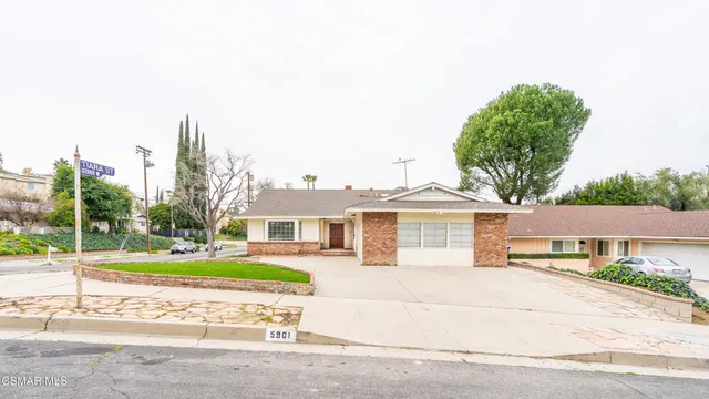 a house with a yard and a palm tree