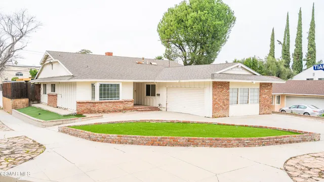 a front view of a house with a porch and a yard