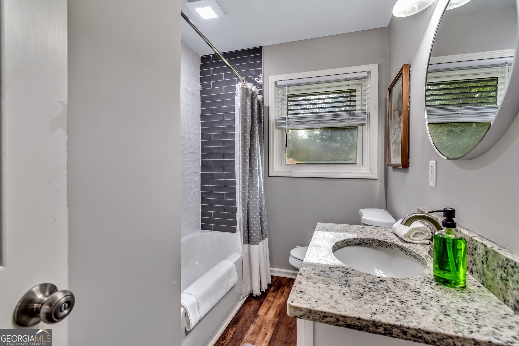 597 South Gordon Road Southwest Mableton, GA 30126 - Photo 12 of 25 a bathroom with a granite countertop sink and a mirror