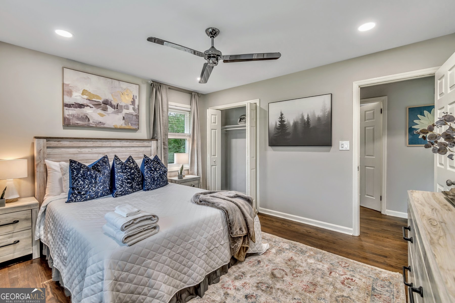 597 South Gordon Road Southwest Mableton, GA 30126 - Photo 15 of 25 a bedroom with a large bed and a chandelier