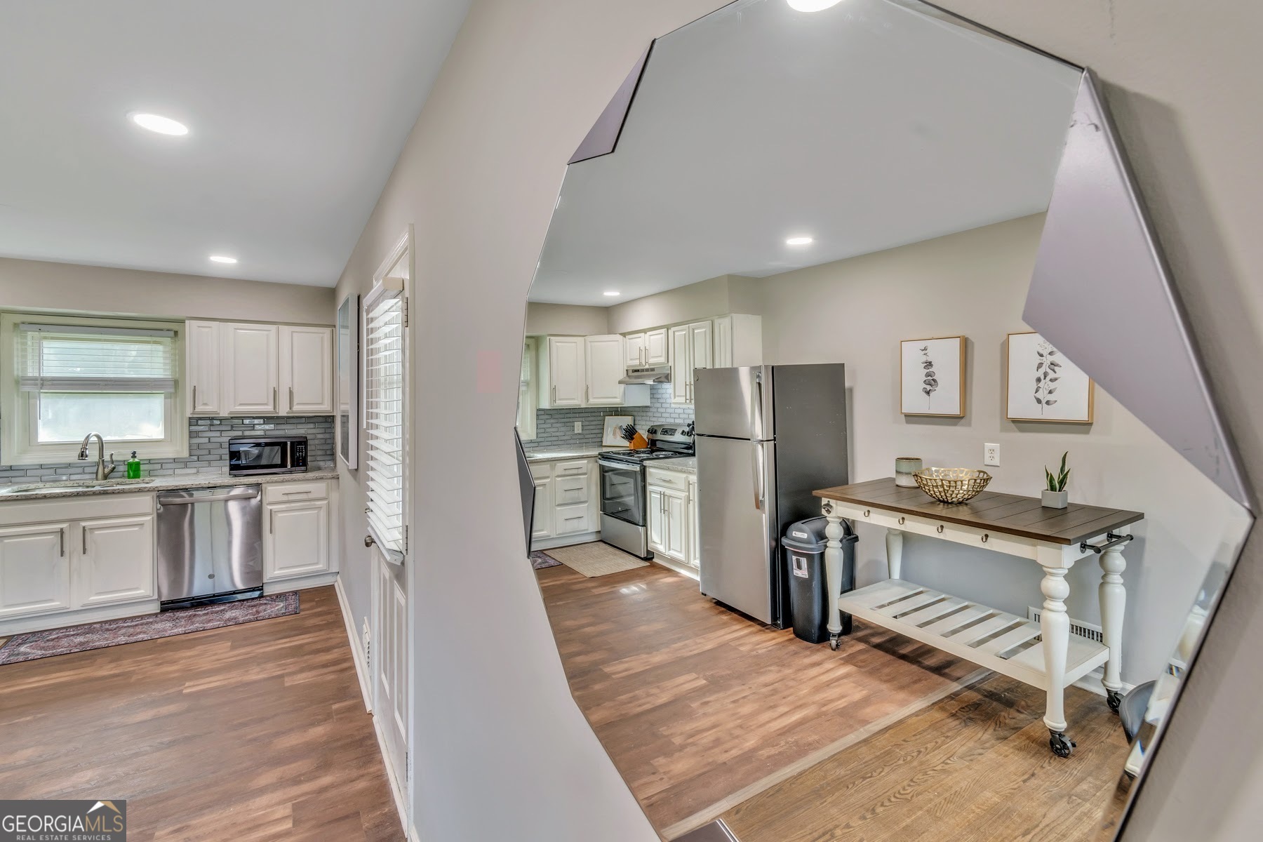 597 South Gordon Road Southwest Mableton, GA 30126 - Photo 23 of 25 a kitchen with white cabinets and stainless steel appliances