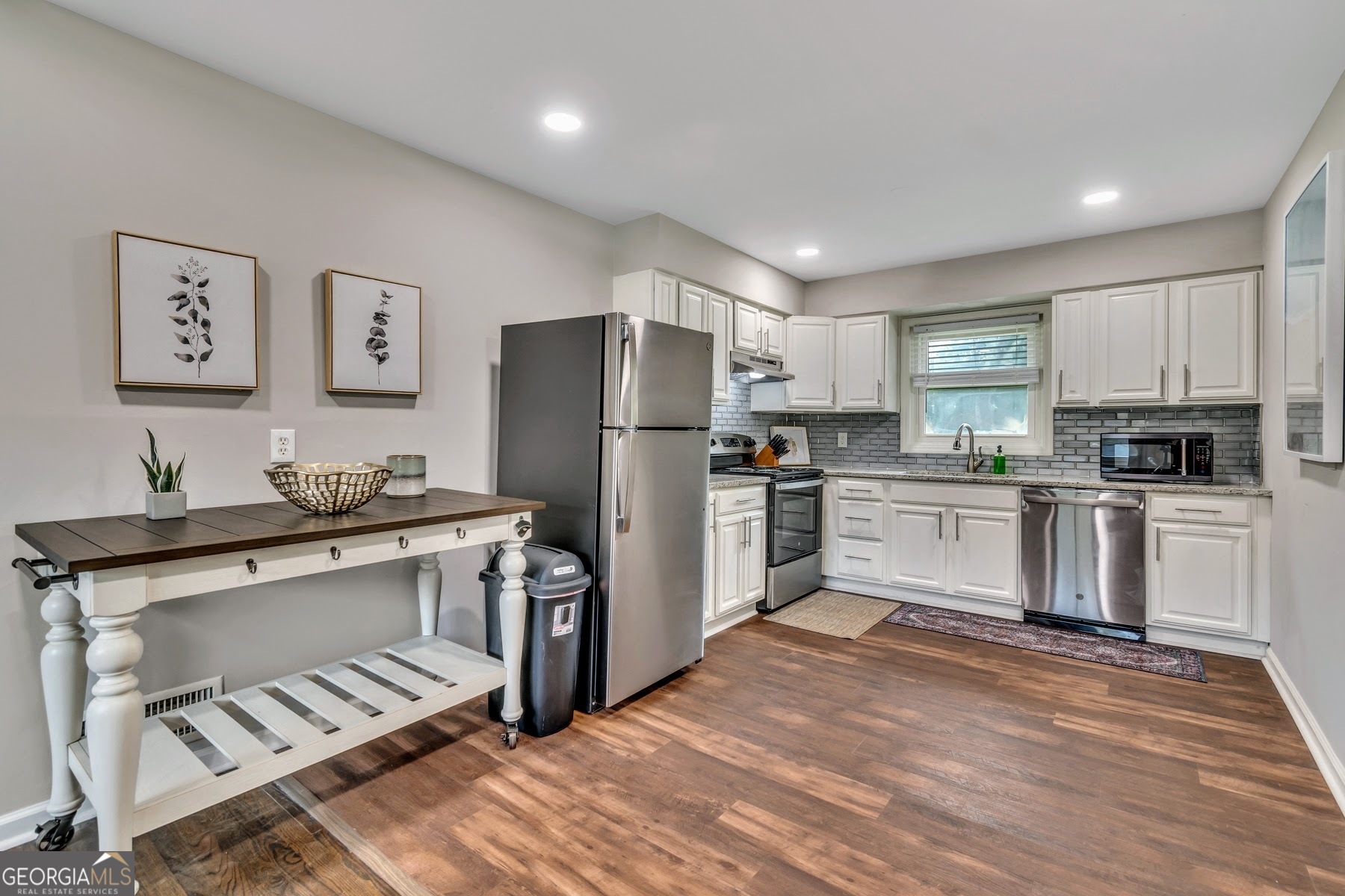 597 South Gordon Road Southwest Mableton, GA 30126 - Photo 6 of 25 a kitchen with granite countertop a refrigerator stove top oven and sink