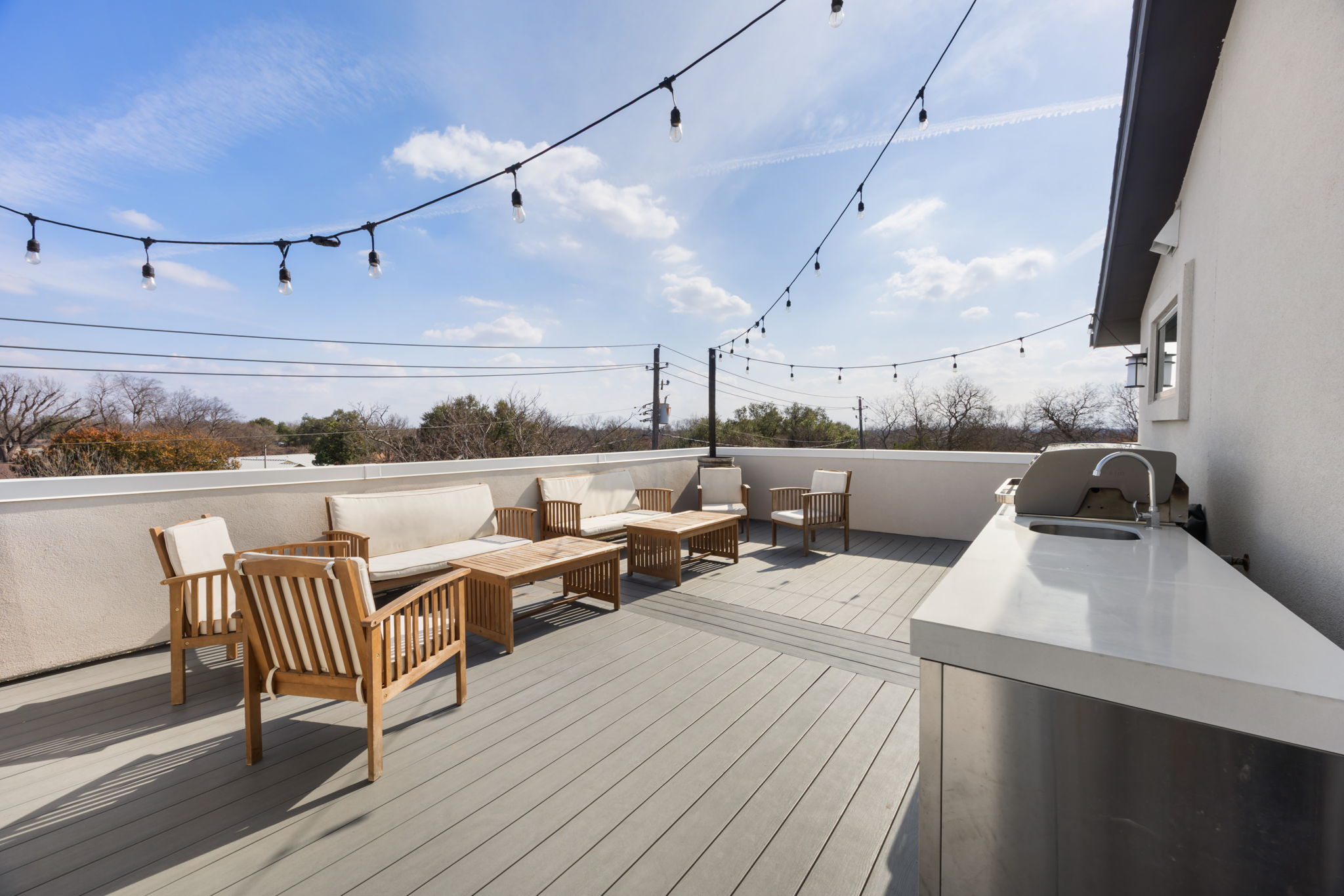 1417 Kramer Lane, Unit 14 Austin, TX 78758 - Photo 1 of 33 Wooden terrace with outdoor seating and a sink
