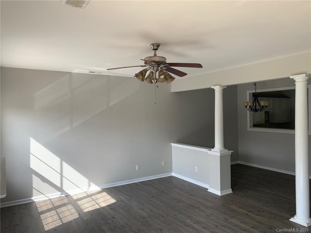9730 Bailey Road Cornelius, NC 28031 - Photo 2 of 22 a view of an empty room with wooden floor and a ceiling fan