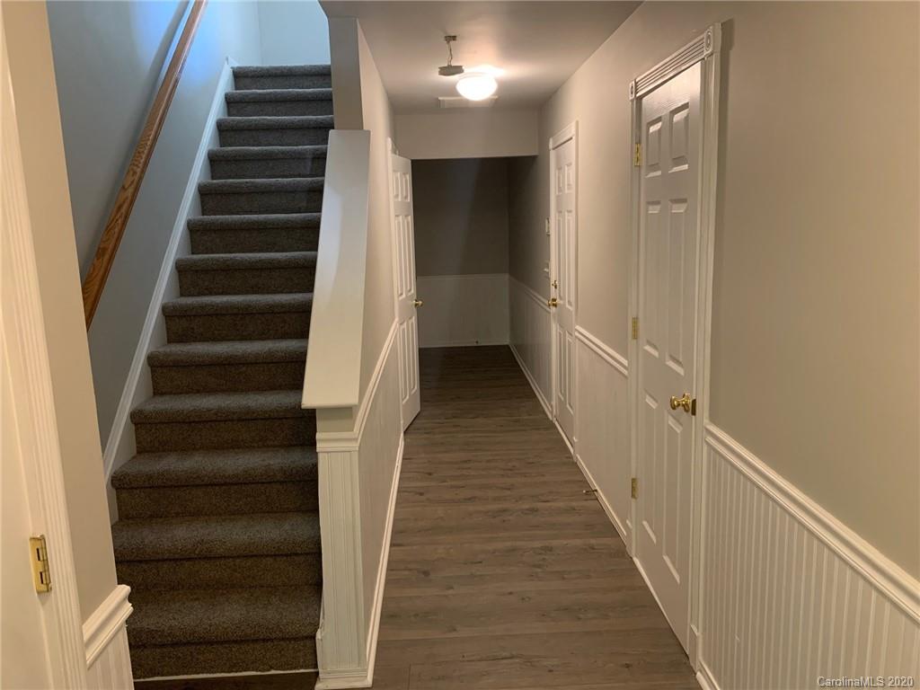 9730 Bailey Road Cornelius, NC 28031 - Photo 17 of 22 a view of a hallway with wooden floor and entryway