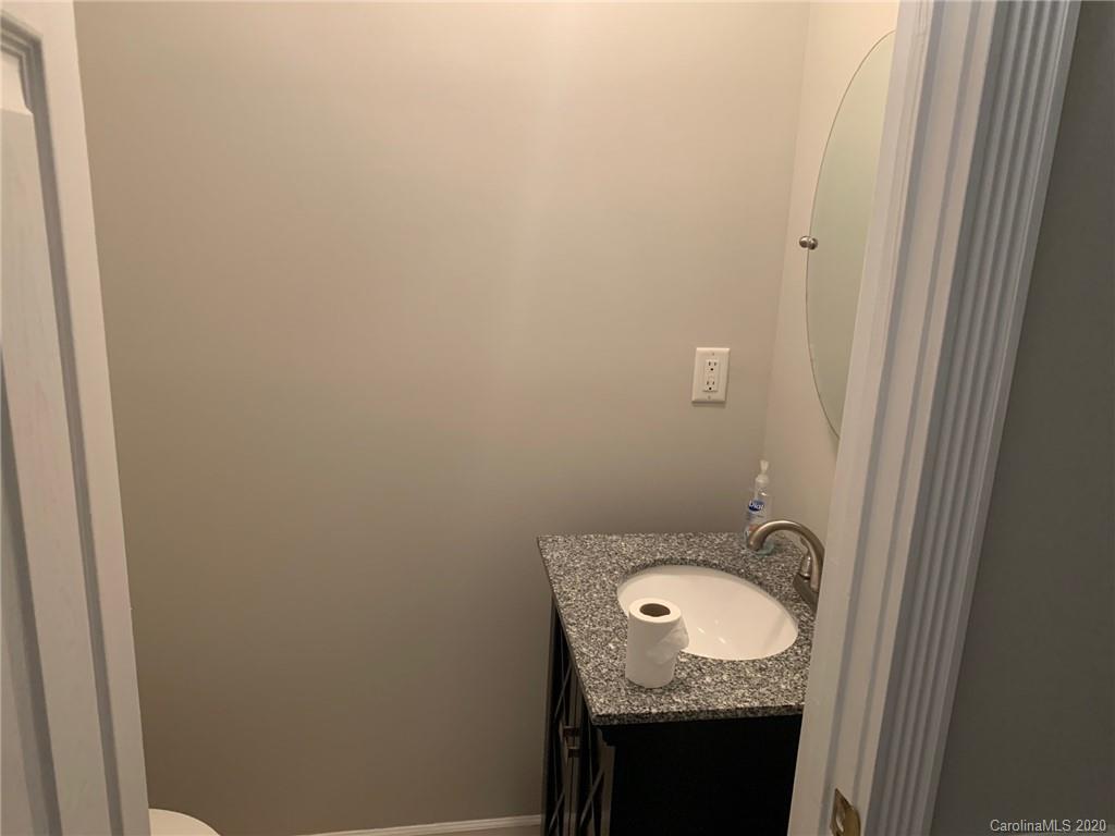 9730 Bailey Road Cornelius, NC 28031 - Photo 19 of 22 a bathroom with a granite countertop sink and a mirror
