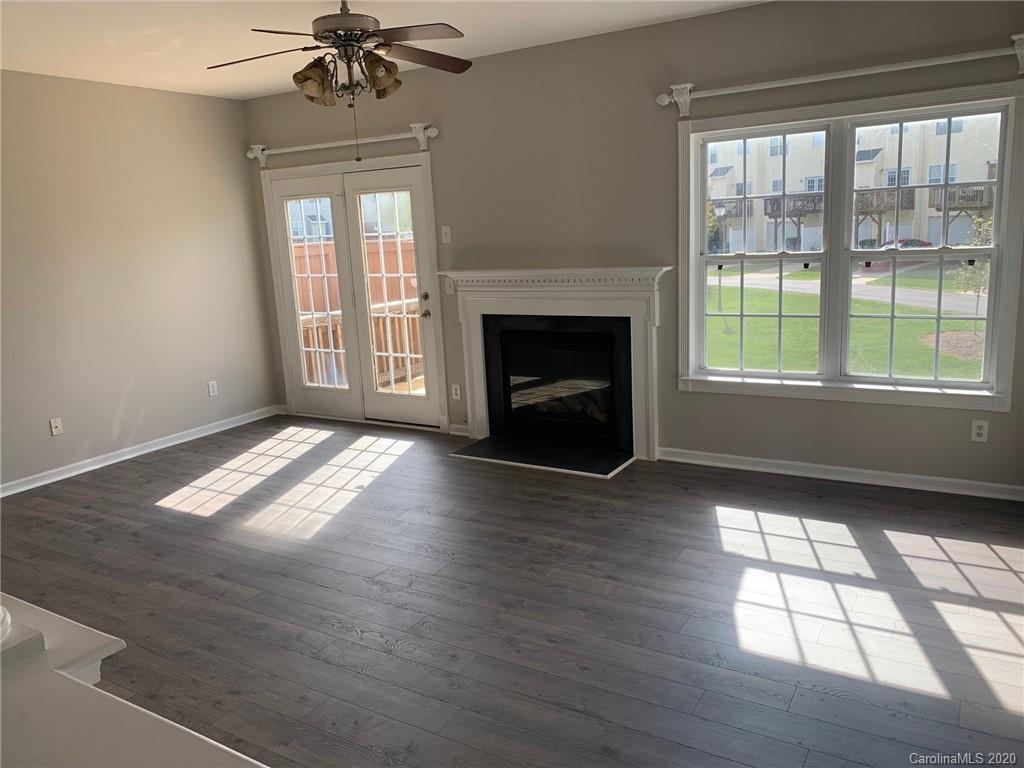 9730 Bailey Road Cornelius, NC 28031 - Photo 3 of 22 a view of empty room with wooden floor and fireplace