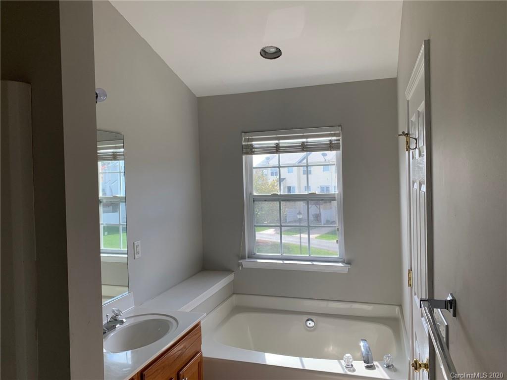 9730 Bailey Road Cornelius, NC 28031 - Photo 9 of 22 a bath room with a bath tub and a sink
