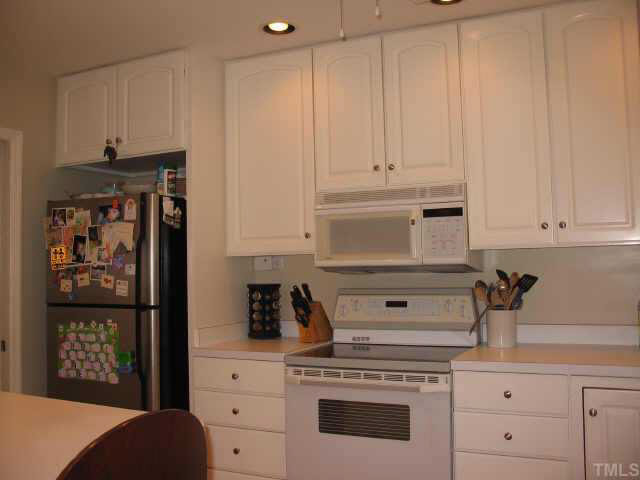 416 Crescent Court Raleigh, NC 27609 - Photo 4 of 10 Bright, sunny kitchen with raised panelled cabinetry, electric range, microwave and new dishwasher. Other