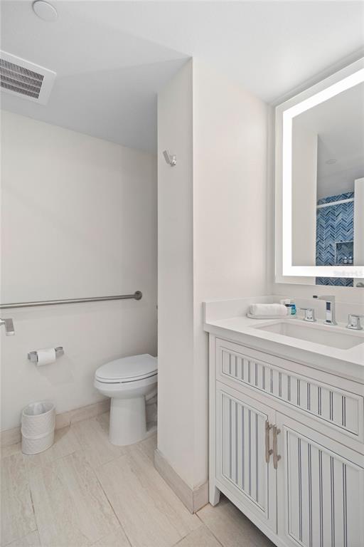 240 Sands Point Road, Unit 4104 Longboat Key, FL 34228 - Photo 20 of 47 a bathroom with a toilet a sink and a window