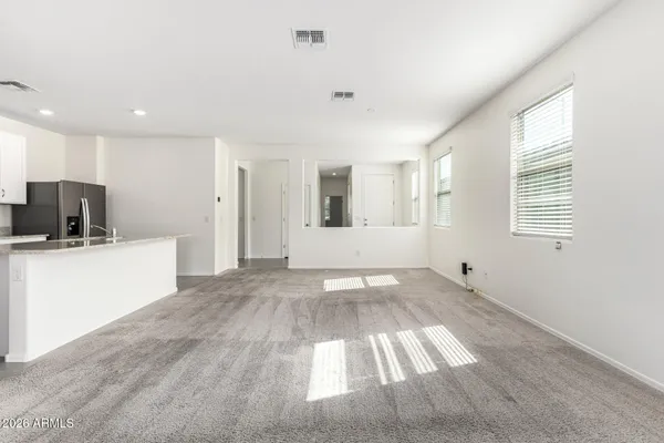 a view of a kitchen with wooden floor and a sink