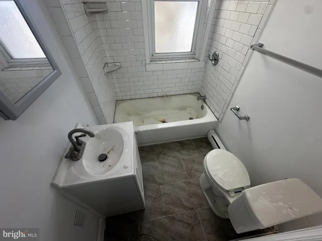 a bathroom with a toilet sink and tub