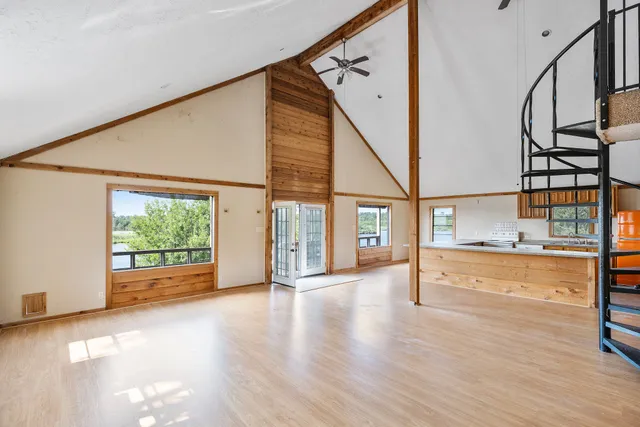a kitchen with stainless steel appliances granite countertop wooden cabinets a sink and a large window