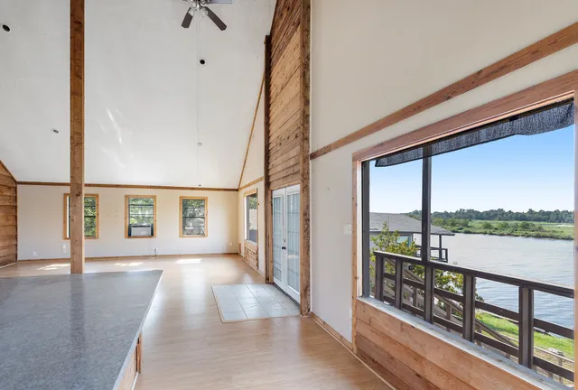 a view of a room with a stylish ceiling fan and entryway