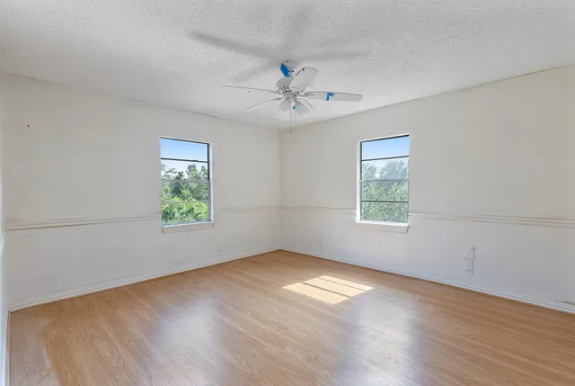 a bathroom with a granite countertop sink and a bathtub